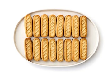 A top down view of a white plate filled with golden brown crispy breadsticks arranged in neat rows