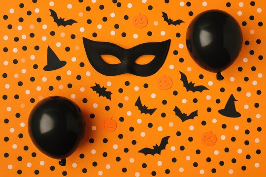 Halloween Party Scene with Black Mask Black Balloons and Witch Hats decoration orange background