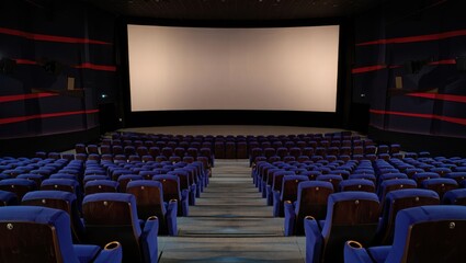 Fototapeta premium Empty Movie Theater Auditorium with Blue Seats and Large Screen Ready for Film Presentation Entertainment and Relaxation Concept for Cinema Industry