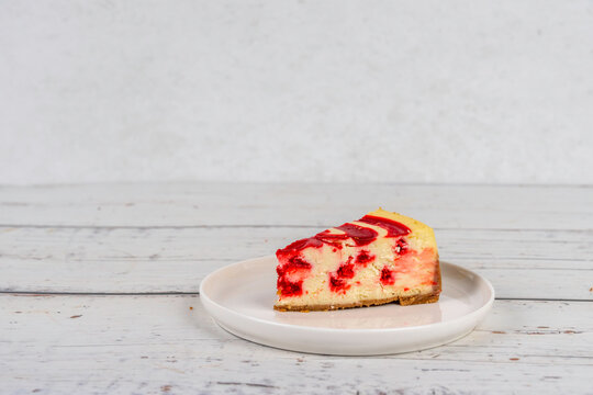 Slice of strawberry swirl new york style cheese cake 