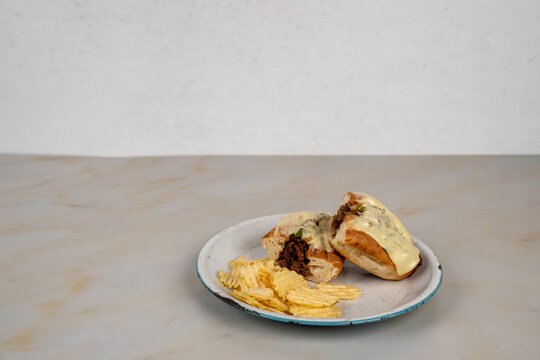 Philly cheese steak sandwich with potato chips 
