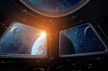 View from the cabin of a spaceship to the planet Earth and the sunrise. View from outer space. Elements of this image furnished by NASA.