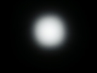 Abstract white light glow on black background with radial gradient