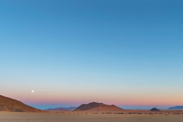 The full moon set in the west before sunrise
