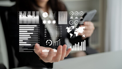 A business professional engages with data visualization tools, using a smartphone to enhance understanding during a strategic meeting in a modern workspace. Impute