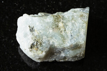 sample of raw gray labradorite mineral on black
