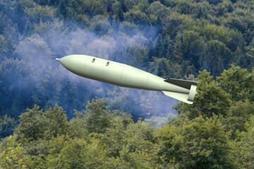 An aerial bomb with a high-explosive warhead flying at low altitude.
