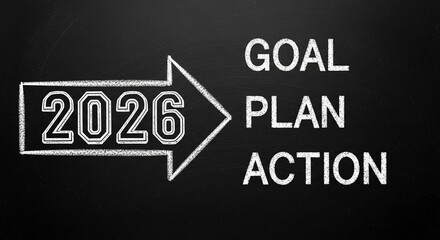 Photo of the year 2026 is written on a blackboard with an arrow pointing to the words goal plan and action