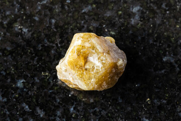 raw single green grossular garnet crystal on black