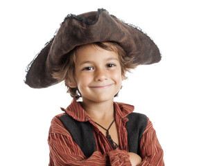 A cute young boy dressed up as a pirate smiles at the camera.