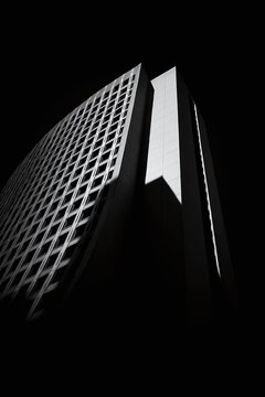Black and White Architectural Contrast &ndash; Curved Grid Facade and Rectangular Tower in Dramatic Light