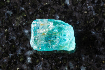 rough starlite blue zircon mineral on black