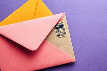 Close-up of colorful envelopes with a vintage stamp.