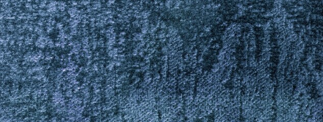 Navy blue fluffy background of soft shiny velour fabric, macro. Texture of dark denim velvet textile backdrop