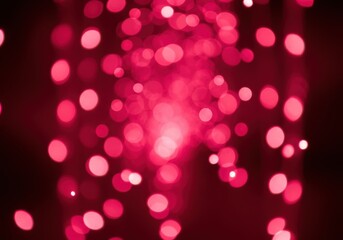Abstract red bokeh background with blurred lights and sparkles, creating a festive and magical atmosphere