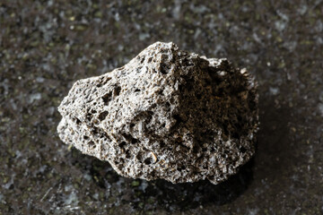 sample of rough pumice lava stone on black
