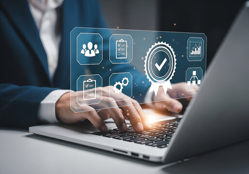 Photo of businessman using a laptop with a quality assurance graphic overlay representing standards and certification