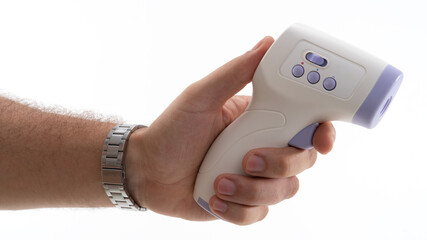 Hand holding a digital thermometer in a clinical setting for temperature measurement