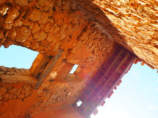 Requena,19th century telegraph tower in Mediterranean countryside, historic communication building under bright blue sky 