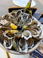 Oysters with lemon and sauce in a restaurant. French cuisine