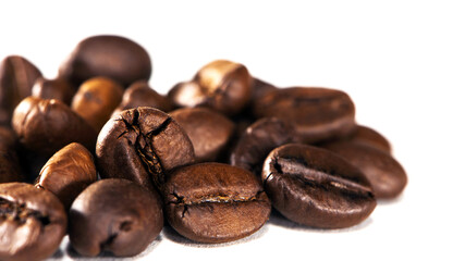 black coffee beans on a white background. Close-up of roasted coffee beans heap isolated on white. aromatic morning drink, invigorating black coffee. macro photo, close-up, on a white background