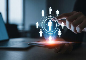 Photo of hand touching target customer icon on smartphone screen representing business marketing and communication strategy