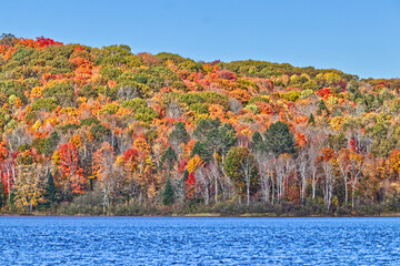 Quiet blue waters and colorful fall leaves - typical Canadian fall scene
