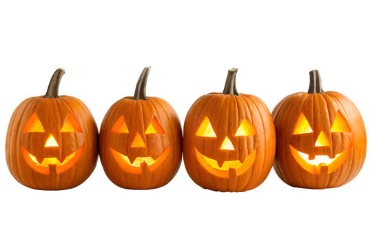 Four spooky jack o lanterns glowing with light isolated on transparent background