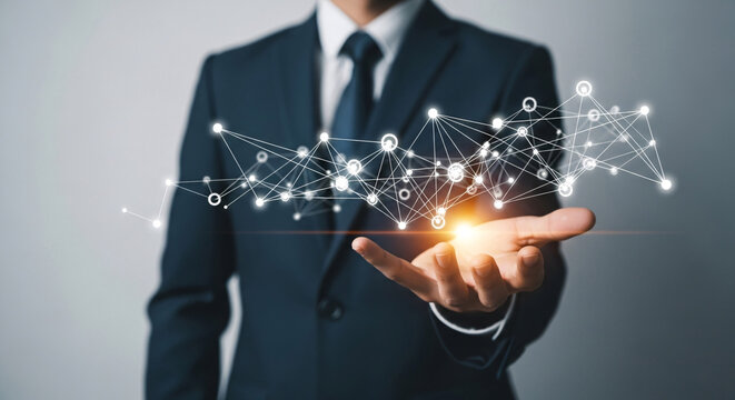 Businessman holds glowing network of connections in his palm, representing global connectivity and