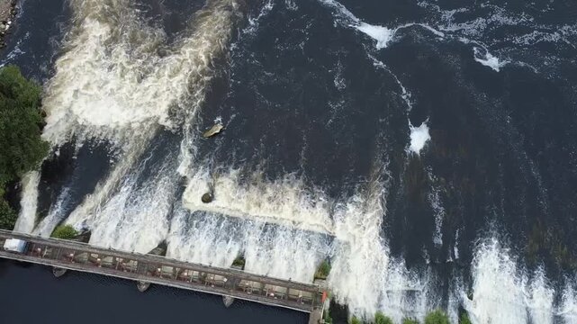 Sluice gates on the River Shannon at Tarmonbarry, County Roscommon, Ireland, regulating river flow and water levels in a rural setting.