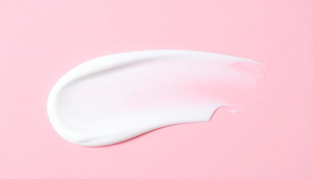 Creamy body lotion smear texture on pastel pink backdrop. Face cream. Softening, skin care.