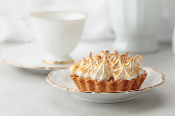 Meringue tart on a white marble countertop.