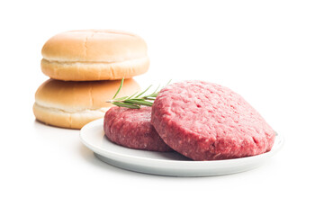 Raw burger beef patties on plate isolated on white background.