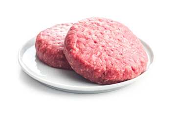 Raw burger beef patties on plate isolated on white background.