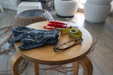 Necessary tools for weaving a rattan basket, top view, gloves, centimeter, knife, and nippers....