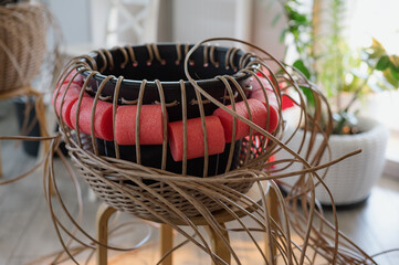 Rattan basket in the process of weaving. A woman's hobby. Natural textures and patterns that create a rustic and organic aesthetic. Perfect for home decor, storage, and organization