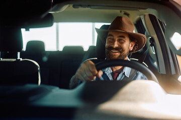 Happy farmer enjoying in driving his pick-up truck.