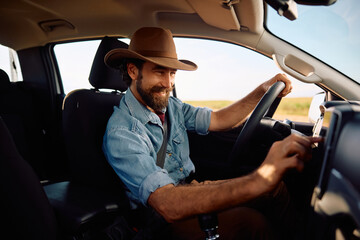 Happy farmer listening music on radio while drinking pick-up truck. © Drazen