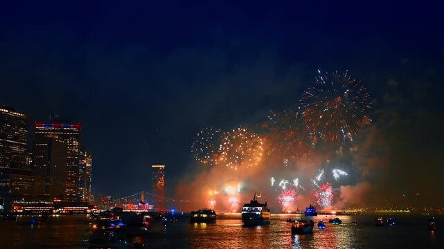 Fantastic firework over the East River in New York, USA. Lots of boats are on the waterscape watching the show.