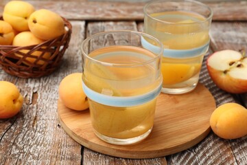 Tasty compot and fruits on wooden table, closeup