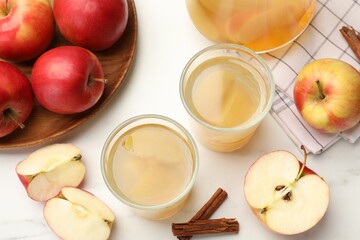 Tasty compot with apples and cinnamon on white table, flat lay