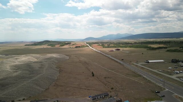 Aerial of Highway 285 through Fairplay Colorado next to construction in summer