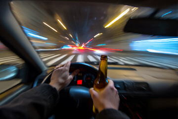 Drunk driver's POV: blurred night road with bottle in hand, dangerous impaired driving scene.