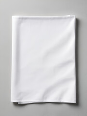 Fototapeta premium top view with white empty kitchen napkin isolated on table background. Folded cloth for mockup with copy space, Flat lay. Minimal style.