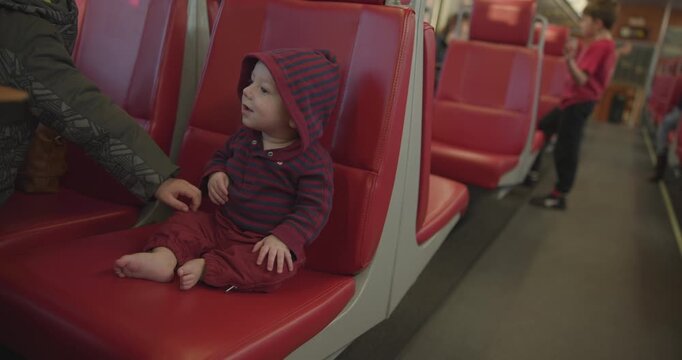 Baby Boy In Hoodie Rides the Public Transportation