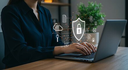 Woman typing on laptop with cybersecurity shield and padlock icon for data protection, internet security, and network safety in the digital world for business and privacy