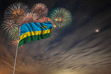 Waving National flag of Rwanda and holiday fireworks
