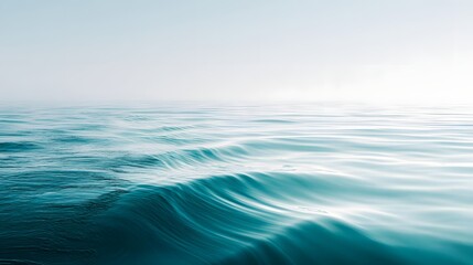Fototapeta premium Gentle ocean waves in soft teal hues.