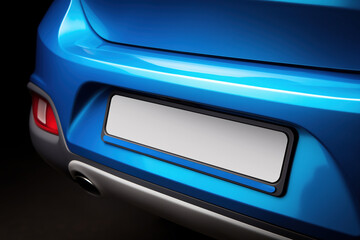 Close-up view of a sleek blue car's rear with an empty license plate space