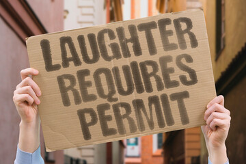 Laughter requires permit. A protest-style cardboard banner questions why happiness is policed. FREEDOM. RIGHTS. SOCIETY. AUTHORITY. LIBERTY. EQUALITY. RESISTANCE